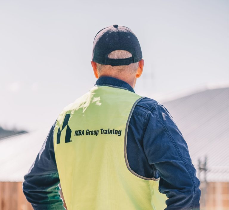 A construction worker in high-visibility safety gear on site