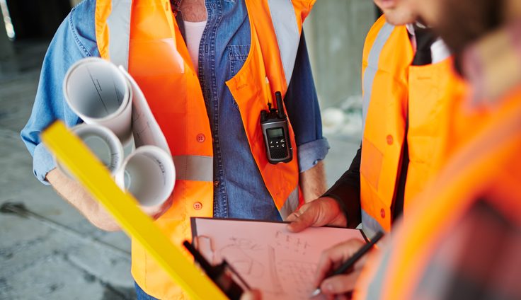 Site supervisor reviewing plans on a construction site
