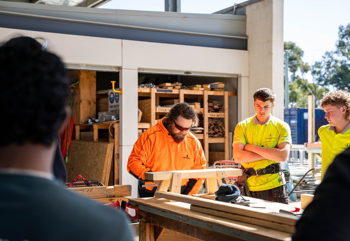 Construction students in high-vis on site during practical training