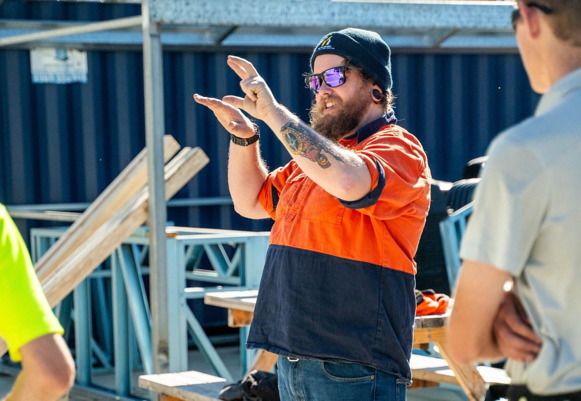 Site supervisor reviewing plans with a colleague on a building site