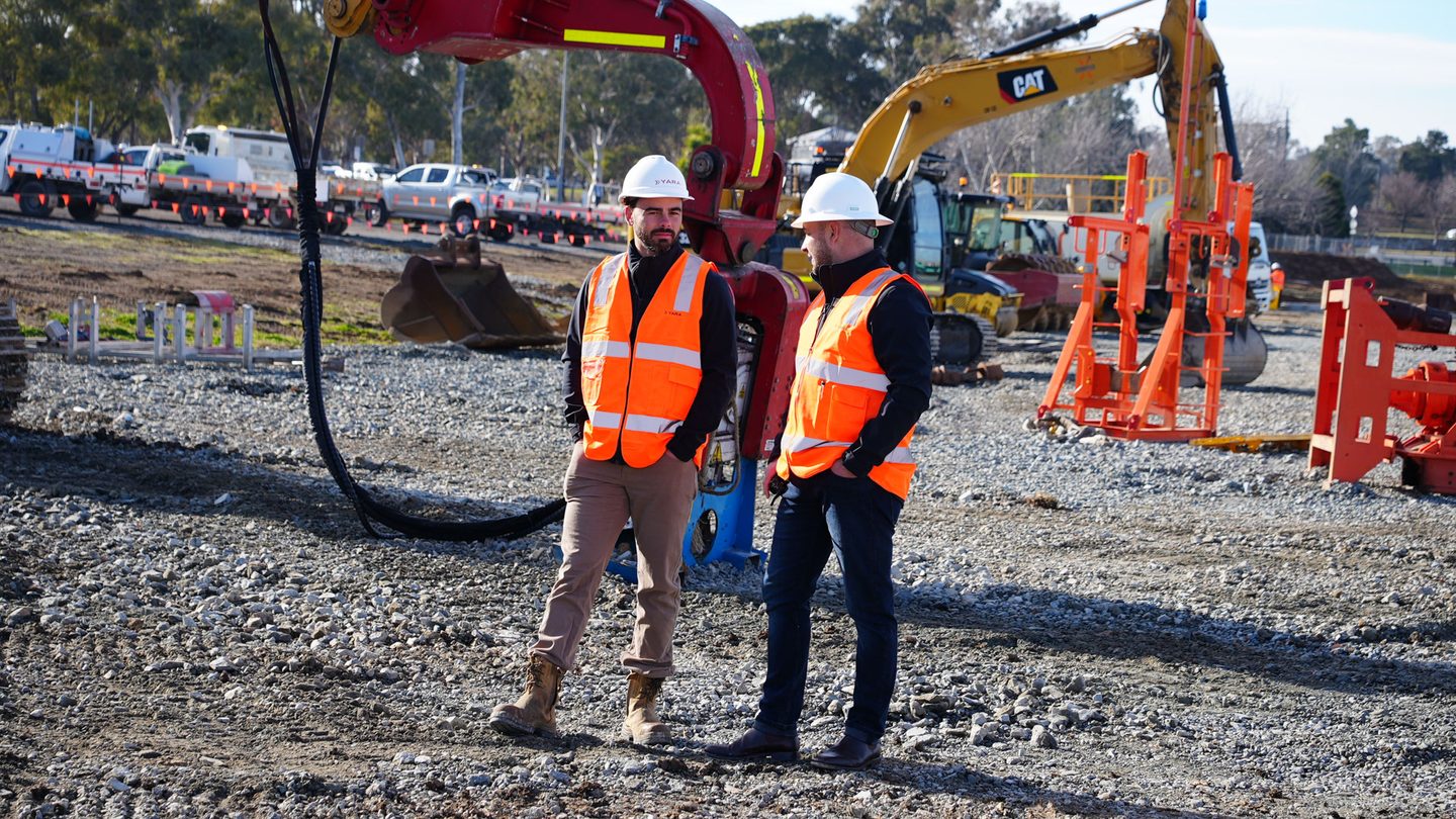 Civil construction workers on an active site with heavy machinery